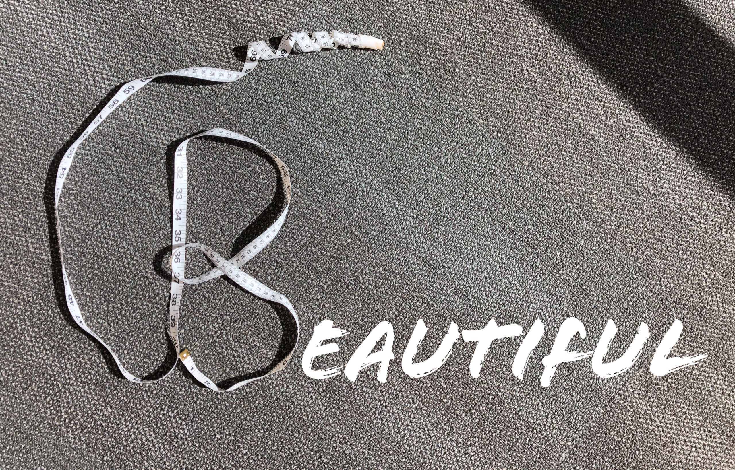 Letter "B" made with a measuring tape. The rest of the word "beautiful" spelt out win letters.