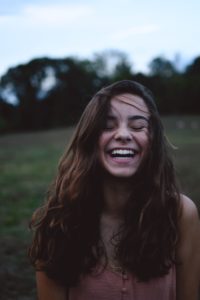 Girl laughing hair blowing in the wind